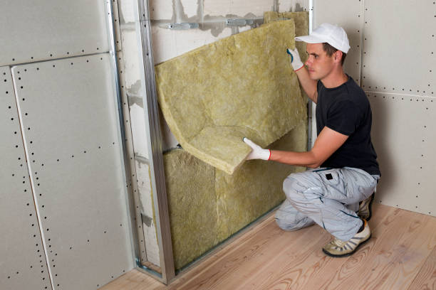 istock Worker in protective gloves insulating rock wool insulation in wooden frame for future house walls for cold barrier. Comfortable warm home, economy, construction and renovation concept 1156942476