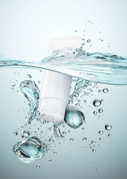 istock moisturizing cosmetic tube product package falling to water. 1156944331