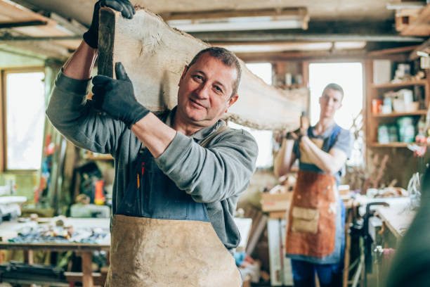 istock Carpenters carrying a wood plank 1156945378