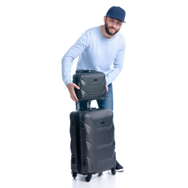istock Man in jeans with travel suitcase standing 1156945447