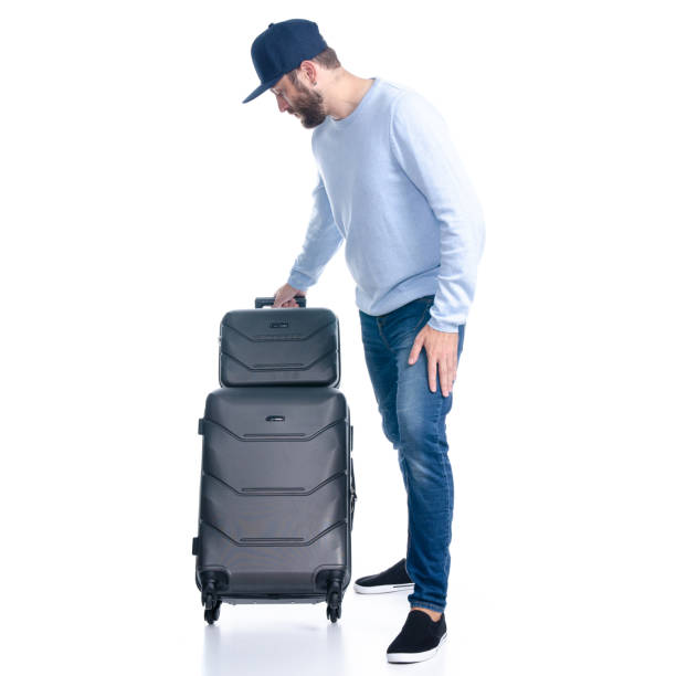 istock Man in jeans with travel suitcase standing 1156945488