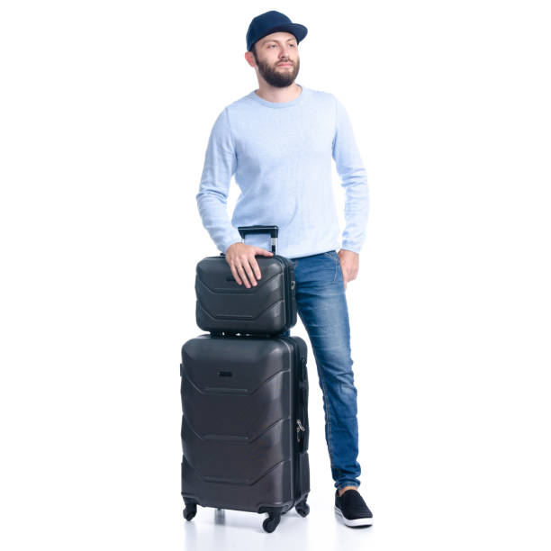 istock Man in jeans with travel suitcase standing 1156945490