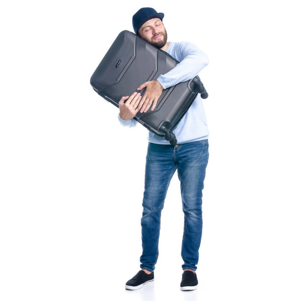 istock Man in jeans holding travel suitcase standing 1156945526
