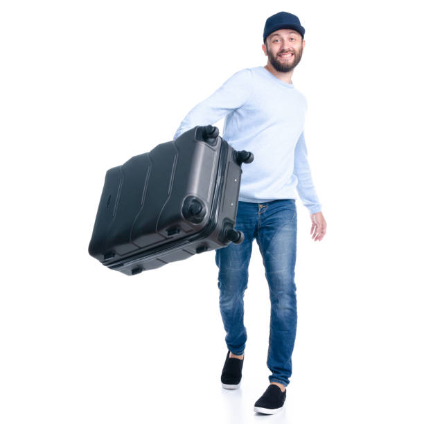istock Man in jeans holding throws travel suitcase standing 1156945541