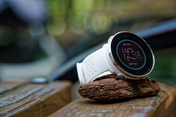 Close-up sport watch for running white color on wooden bench. Fitness watch for tracking daily activity and power training. Kyiv, Ukraine - July 2, 2019: Polar watch for athlete runners. Close-up sport watch for running white color on wooden bench. Fitness watch for tracking daily activity and power training elefant stock pictures, royalty-free photos & images