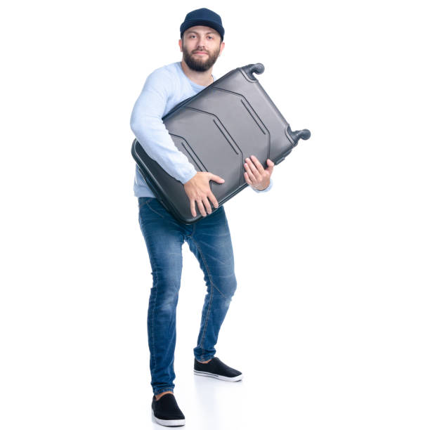 istock Man in jeans holding travel suitcase standing 1156945631