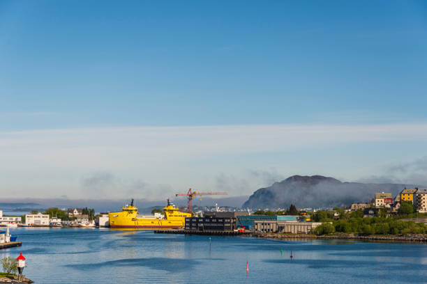 Alesund downtown seen from the island of Hessa in a sunny and foggy day