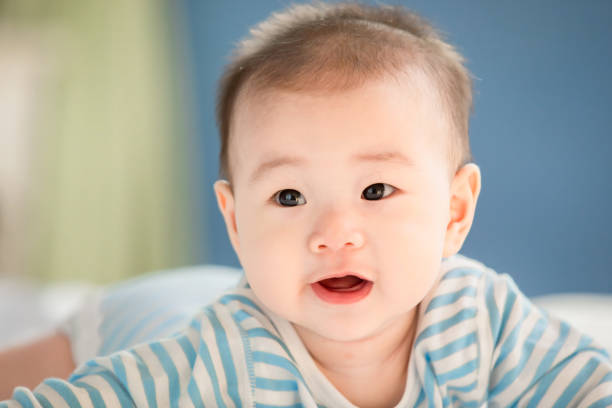 istock baby lying on the bed 1156946114