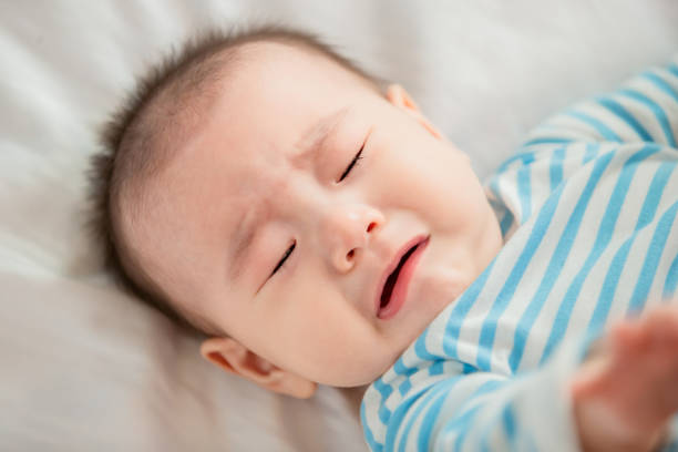 istock baby lying on the bed 1156946995
