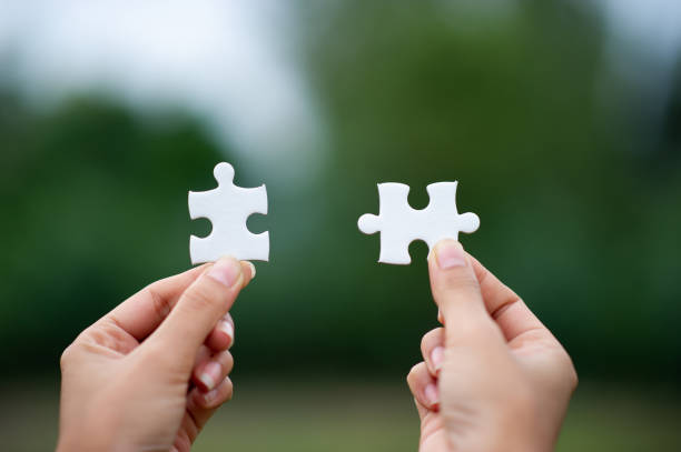 istock Hands and puzzles, important pieces of teamwork Teamwork concept 1156947180