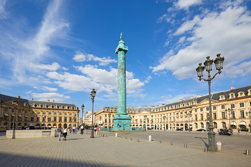 PARIS, FRANCE - JULY 21, 2017: Place Vendome with people and tourists in a sunny summer day, blue sky in Paris, France.
