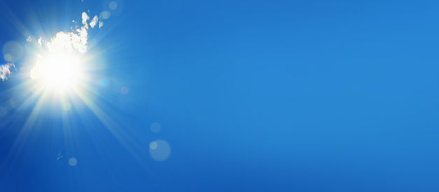 background image of blue sky with shining sun
