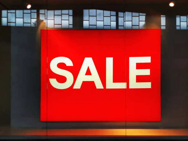 istock Illuminated Red Board with White SALE Text at Retail Store 1156948827