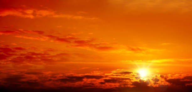 istock empty cloudscape of orange colored sunset sky with shining sun 1156950372