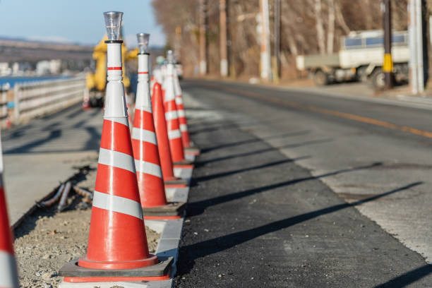 istock Orange color traffic cones in row for road maintenance work site. 1156951453