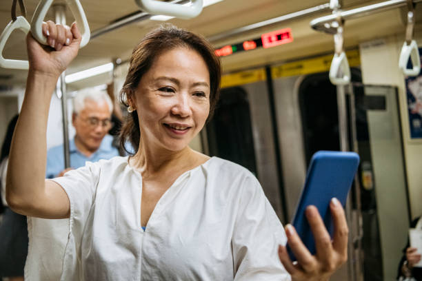 istock Senior woman commuting and using smartphone 1156954252