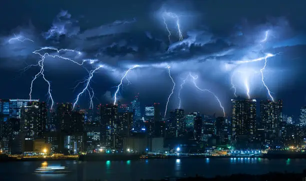 Photo of Lightning storm over city in blue light