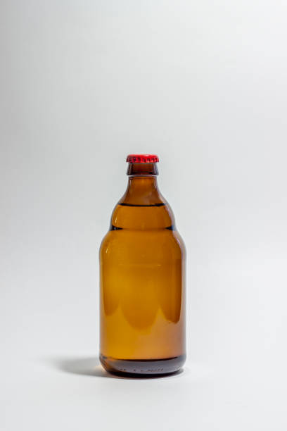 istock Beer bottle with a red cork on a gray background. Design. Minimalism. Creative idea. Mock-up. 1156955323