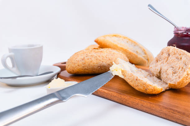 Wooden board with tasty breakfast toasts and jam