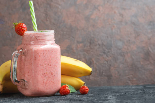 Strawberry smoothie with banana or strawberry milkshake in a glass jar with copyspace Strawberry smoothie with banana or strawberry milkshake in a glass jar with copyspace Strawberry Banana Smoothie stock pictures, royalty-free photos & images