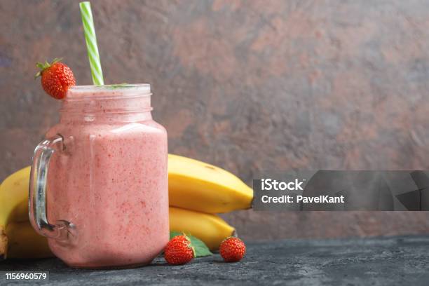 Strawberry Smoothie With Banana Or Strawberry Milkshake In A Glass Jar With Copyspace Stock Photo - Download Image Now