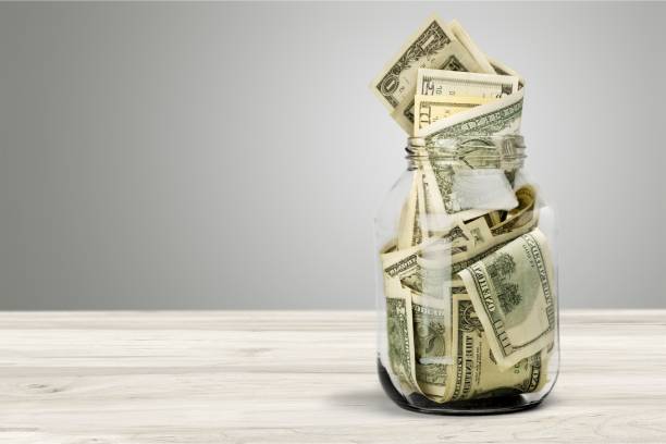 Currency. Glass jar for money on background savings stock pictures, royalty-free photos & images