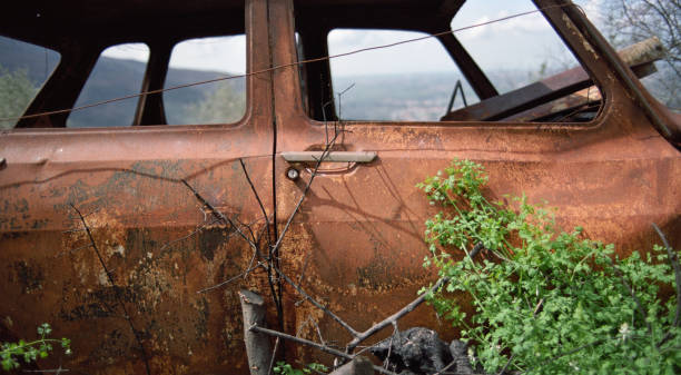 rusty abandoned car in the countryside