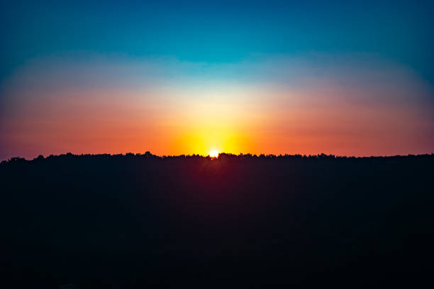 istock Sunrise over the forest on a summer day 1156968370