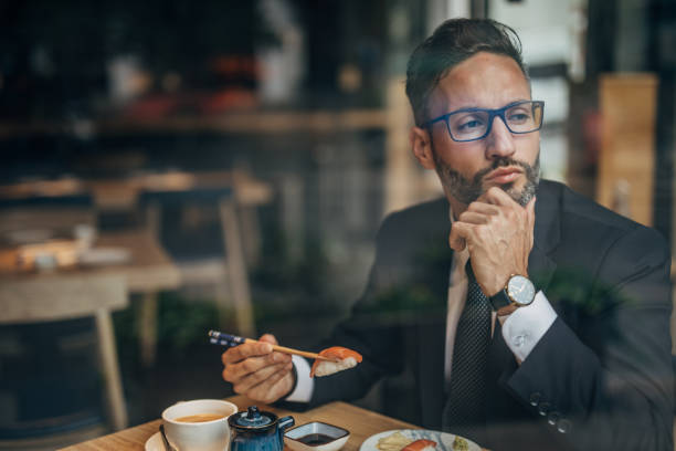 istock Man eating sushi in teh reataurant 1156973405
