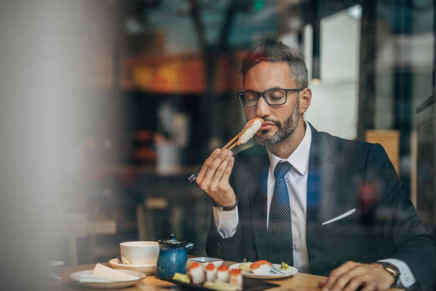istock Man eating sushi in teh reataurant 1156973413