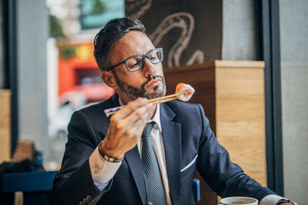 istock Man eating sushi in teh reataurant 1156973452