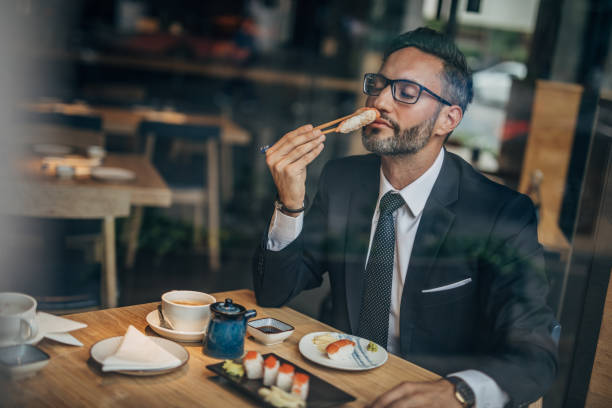 istock Man eating sushi in teh reataurant 1156973533