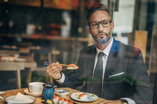 istock Man eating sushi in teh reataurant 1156973552