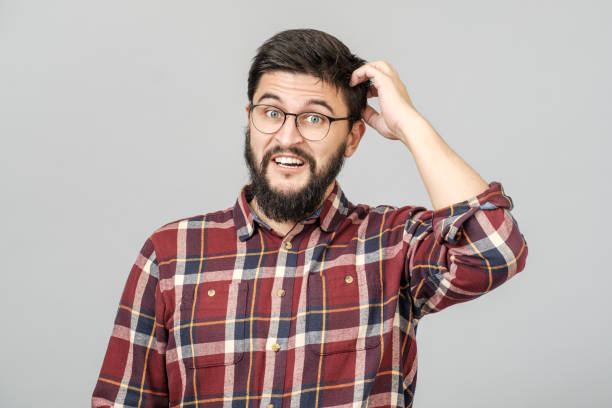 istock Portrait of focused smart male model with with thoughtful determined expression, thinking. Isolated over grey 1156973631