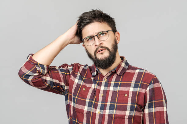 istock Portrait of focused smart male model with with thoughtful determined expression, thinking. Isolated over grey 1156973633