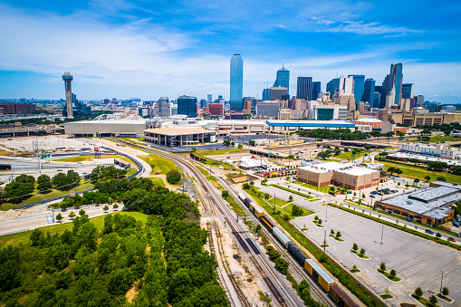 Dallas Texas Cityscape aerial drone view near railroad tracks and green space with skyline in background