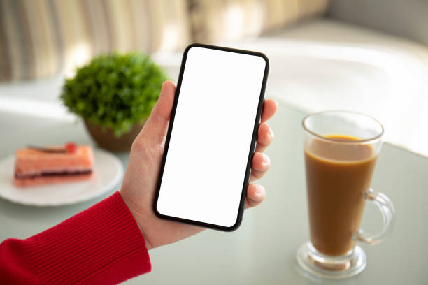 istock female hand holding phone with isolated screen in a cafe 1156976699