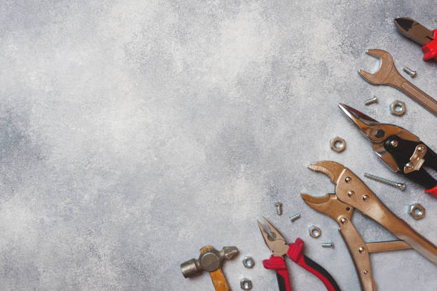 istock Pliers, screwdrivers and wrench combination on grey concrete background with copy space. Professional ergonomic repair tools. 1156978980