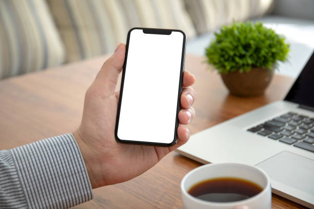 istock male hands holding phone with isolated screen in the office 1156981347