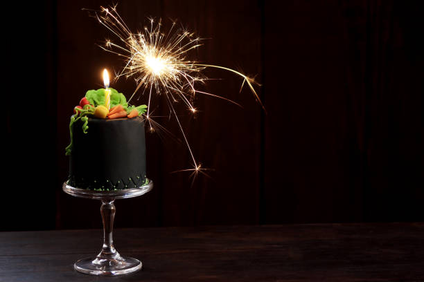 istock Birthday cake with candle, sparkler and gum paste vegetables 1156982023