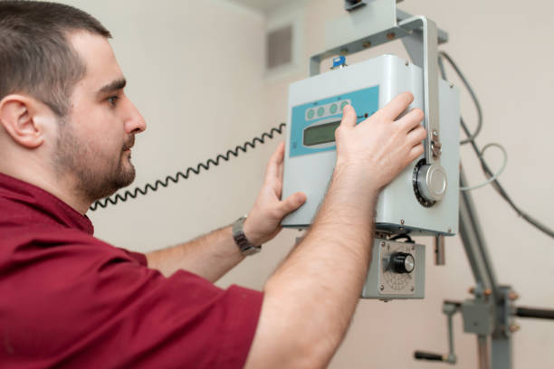 istock The doctor radiologist sets up an old veterinary X-ray machine before work at a veterinary hospital. 1156982024