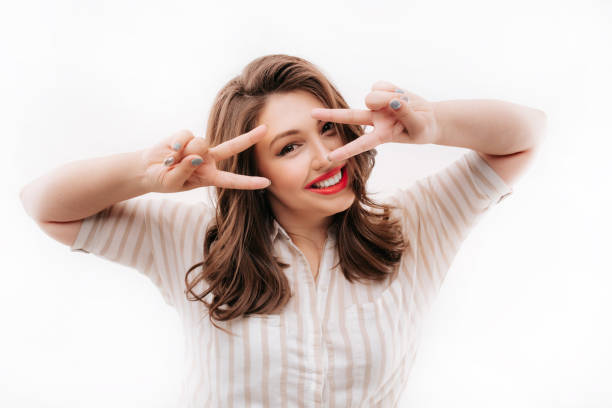 istock Smiling plus size model gesturing V sign near face 1156988481