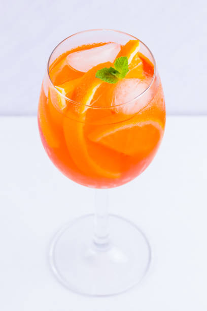 istock Cocktail Spritz with mint leaves on a white background. Italian cocktail Spritz on white background 1156988558