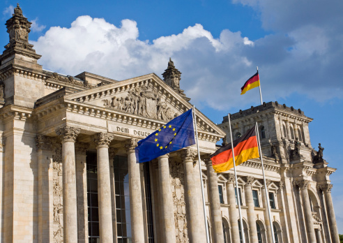 Reichstag in Berlin with German and European flag