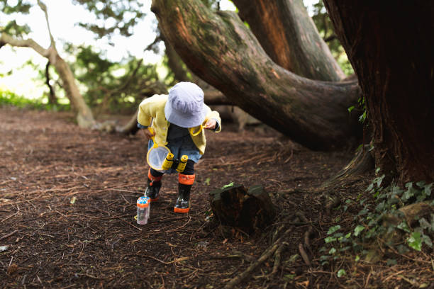 istock toddler girl playing exploration in spring park 1156992158