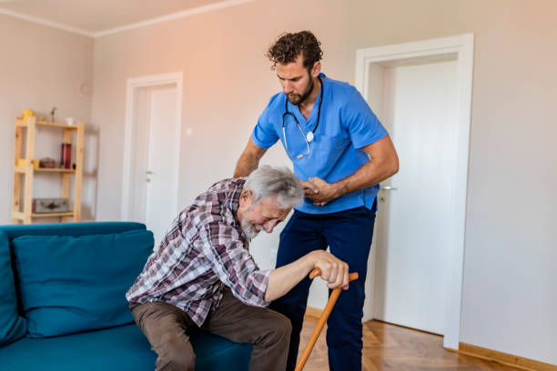 istock Care Worker Helping Senior Man To Get Up 1156995357