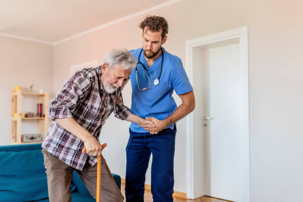 istock Care Worker Helping Senior Man To Get Up 1156995407