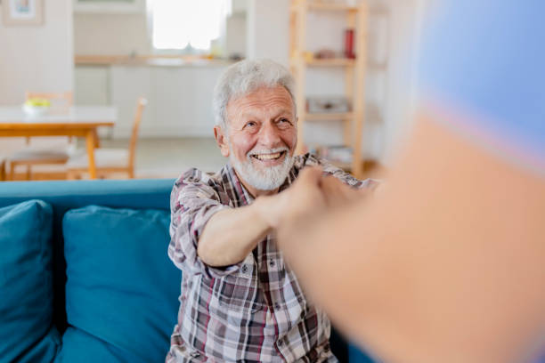 istock Caregiver Helping Senior Man 1156995470