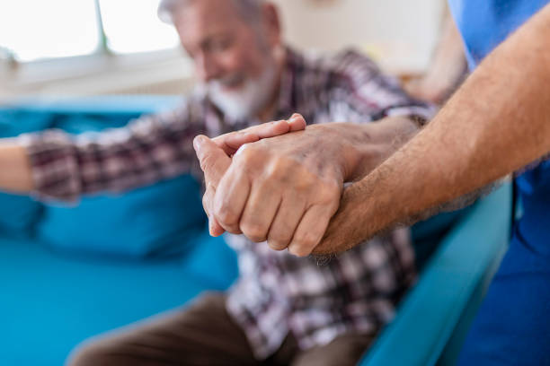 istock Doctor Holding Elderly Man Hand With Care 1156995590
