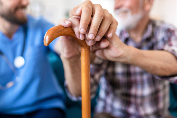 istock Home Caregiver Showing Support for Elderly Patient 1156996469